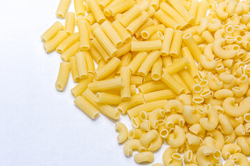 Uncooked raw Italian pipe rigate and rigatoni pasta on isolated white background.