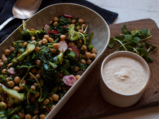 Rustic chickpea fresh green salad in bowl on table.