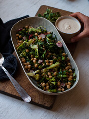 Rustic chickpea fresh green salad in bowl on table.