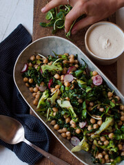 Rustic chickpea fresh green salad in bowl on table.