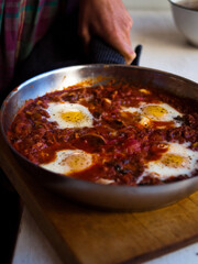 Home made shakshuka in rustic kitchen