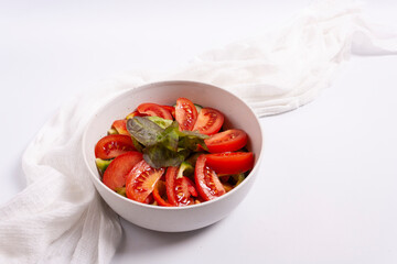 Fresh vegetable salad: tomatoes, cucumber, peppers, herbs, olive oil. Healthy food concept.