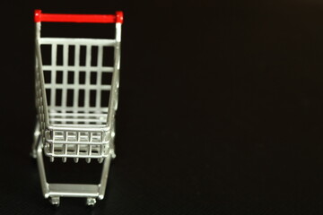 Miniature shopping cart model scene represent online shopping and retail business concept related idea.