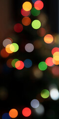 Background of Christmas tree lights, colorful bokeh on a dark background