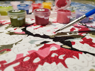 painting on canvas for beginners. Brushes and paints on canvas close-up.