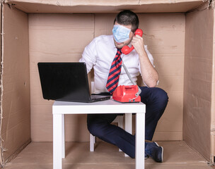 businessman with protective mask on his eyes, talking on the phone with client