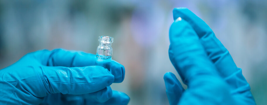 Close Up Of Pharmacist Hands With Developed Vaccine Against Coronavirus, Covid-2019, Production And Develop Of A Coronavirus Vaccine