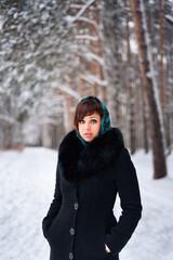 Russian girl in coat and scarf in cold winter