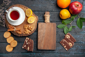 top view cup of tea with lemon and sweets on a dark background photo ceremony drink