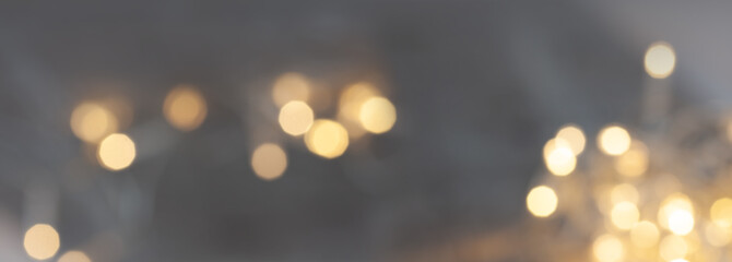Blurred abstract bokeh background with golden light effects and sparks for festive glamorous...