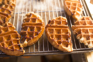 Freshly baked waffles isolated on a metal.