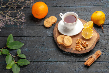 top view cup of tea with fruits and cookies on the dark desk ceremony sweet biscuit sugar