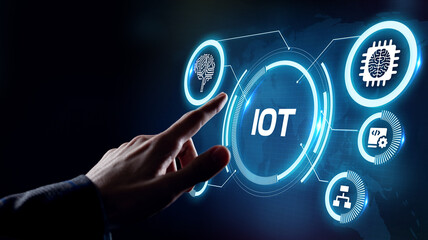 Internet of things - IOT concept. Businessman offer IOT products and solutions. Young businessman  select the abstract chip with text IoT on the virtual display