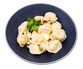 cooked Pelmeni decorated with parsley in bowl