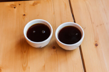 cup of black filter coffee on wooden table