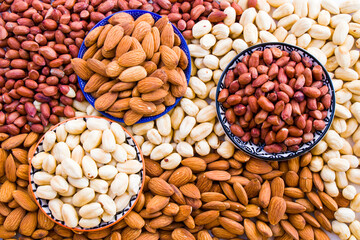 Almonds, peanut and hazelnuts in the bowl, beer and healthy snack