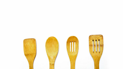 Wooden spoons, spatulas and a rolling pin isolated on white background. Top view, flat lay.