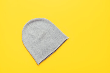 Gray unisex cashmere beanie on yellow background, trendy colors 2021, Top View, Copy Space