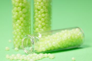 glass bottles with green granules on a green background