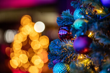 Christmas ball in a tree with an other tree in the background with perfect lights