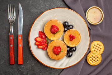 top view yummy pancakes with olives and fruits on dark background sweet fruit cake