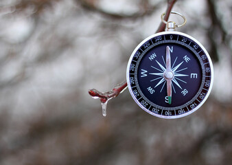 Classic navigation compass on natural background as symbol of tourism with compass, travel with...