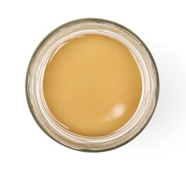 Peanut butter in glass jar isolated on white background, top view