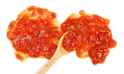 Sauce made from tomatoes, garlic, onions, carrots and basil with wooden spoon, isolated on white background top view 