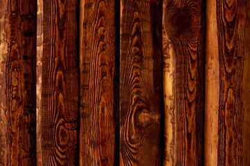 Dark stained brown wood surface with aged boards lined up