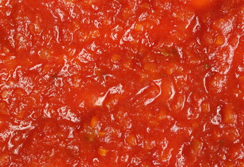 Sauce made from tomatoes, garlic, onions, carrots and basil background and texture