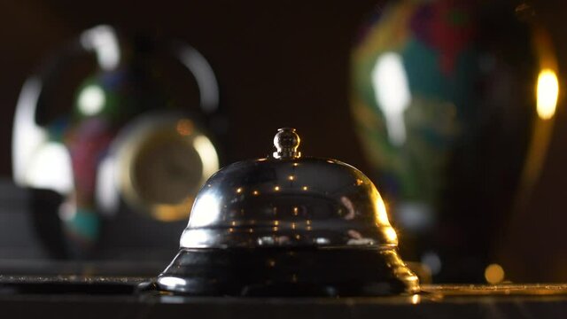 Female ringing the bell in a hotel lobby. Close-up. 4K resolution, slow-motion. High quality 4k footage