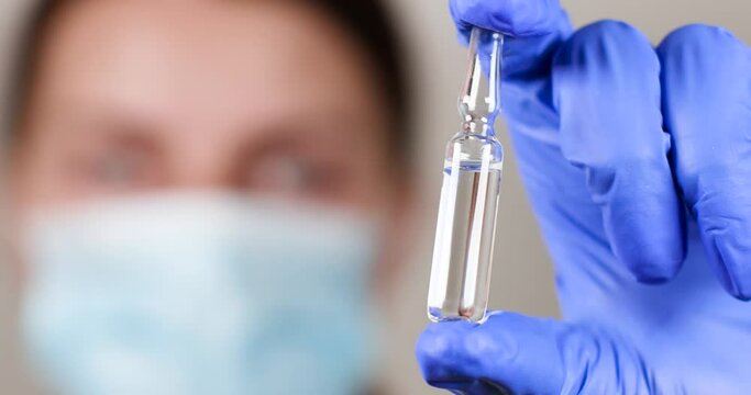 Diabetes. Medical doctor in protective surgical gloves holds insulin medicine ampoule and syringe for injection from diabetes mellitus disease