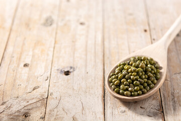 Green soy beans in wooden spoon on wooden table.Copy space