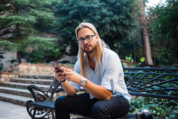 Young male using smartphone on street