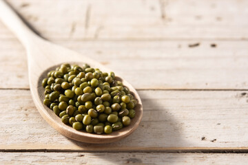 Green soy beans in wooden spoon on wooden table.Copy space
