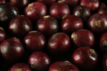 sweet red onions on background