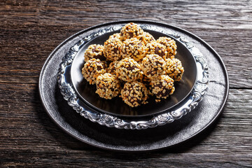 Dark chocolate truffles coated by crushed almonds