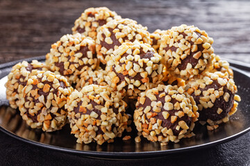 Dark chocolate truffles coated by crushed almonds