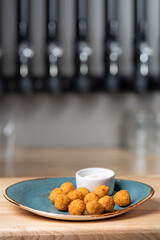 Potato croquettes - mashed potatoes balls breaded and deep fried, served with different sauce.