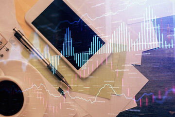 Multi exposure of forex graph hologram over desktop with phone. Top view. Mobile trade platform...