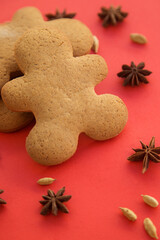 gingerbread in the form of ginger men on a red background, New Year and Christmas photo. 