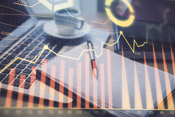 Double exposure of forex chart drawing and desktop with coffee and items on table background. Concept of financial market trading