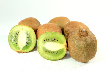 Close up of kiwi fruit and slice kiwi on white background.