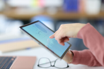 Woman showing her finger to digital tablet closeup