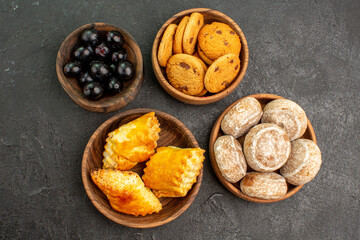 top view delicious sweet cakes with cookies and olives on dark background sweet cake pie