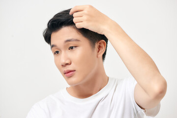 Portrait of healthy man combing his hair with fingers