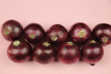 sweet red onions on background