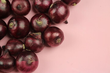sweet red onions on background