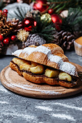 New Year's breakfast with croissants. New Year's croissant with chocolate and baked pineapple