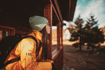attractive girl who hikers resting in a wooden cottage